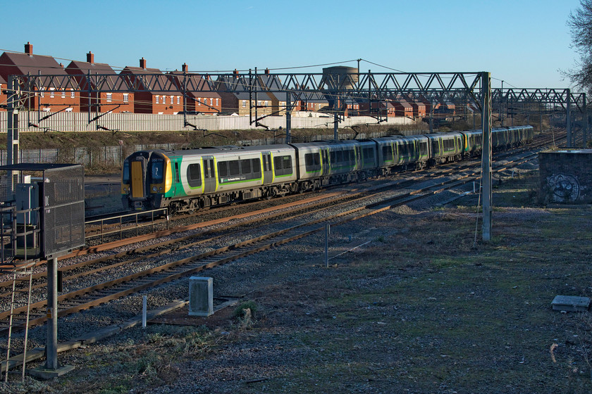 350116 & 350127, LN 12.34 London Euston-Stafford (2Y48, 3L), site of Roade station 
 Catching some lovely afternoon sun 350116 and 350127 pass the site of the former Roade station working the 12.34 Euston to Stafford. The huge new housing development that occupies the former Pianoforte/Simplex factory site is clear in this image. 
 Keywords: 350116 350127 12.34 London Euston-Stafford 2Y48 site of Roade station London Northwestern Desiro