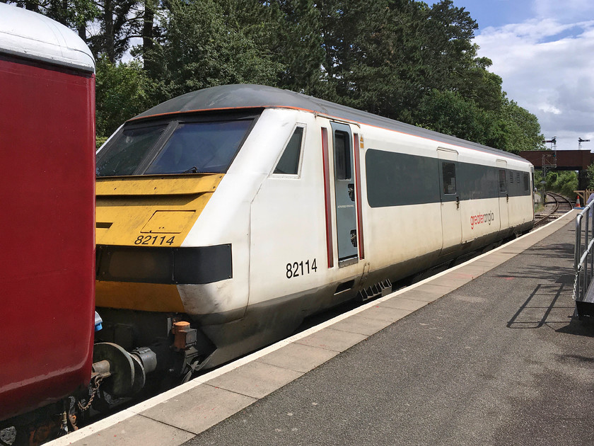 82114, stabled, Pitsford & Brampton station 
 More associated with leading trains from London's Liverpool Street, speeding through the Suffolk countryside or sitting on the blocks at Norwich station, former GA 82114 now has a new home at the NLR! The DVT is going to become part of an air-braked set that the heritage line is planning to operate. I am not sure that sitting in a Mk.III coach being hauled by a diesel on a heritage line is quite what visitors will flock to the NLR for but I suppose that I can see the thinking, see..... https://www.nlr.org.uk/mark-3b-driving-van-trailer-82114-preserved-at-the-northampton-lamport-railway/ 
 Keywords: 82114 Pitsford & Brampton station DVT Driving Van Trailer GA Greater Anglia