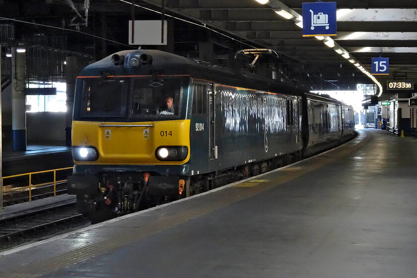 92014, CS 20.45 Inverness, 21.43 Aberdeen & 19.50 Fort William (1M16, 16E), London Euston station 
 Caledonian liveried 92014 comes to a halt at Euston platform fifteen with the 1M16 up Highland Sleeper service. The Lowland service that arrived nearly two hours earlier is composed of two trains that come together at Carstairs Junction. The Highland service is made up of three trains, the 20.45 from Inverness, the 21.43 from Aberdeen and, finally, the 19.50 from Fort William but they converge at Edinburgh station with all this activity taking place between midnight and two in the morning. Hopefully, all the shunting and movement of trains does not wake the passengers who are, hopefully by this time, fast asleep! 
 Keywords: 92014 20.45 Inverness 21.43 Aberdeen 19.50 Fort William 1M16 London Euston station Caledonian sleeper Highland Sleeper