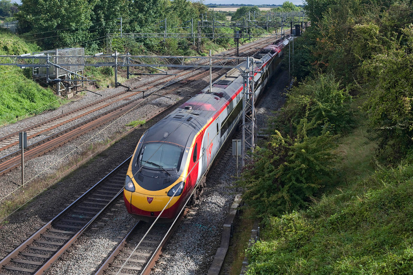 390148, VT 15.03 London Euston-Birmingham New Street (9G28, RT), Victoria Bridge 
 390148, recently named 'Flying Scouseman' races north working the 15.03 Euston to Birmingham New Street. It is seen passing Victoria Bridge on the southern end of the WCML just north of Hanslope Junction. 
 Keywords: 390148 VT 15.03 London Euston-Birmingham New Street 9G28 Victoria Bridge