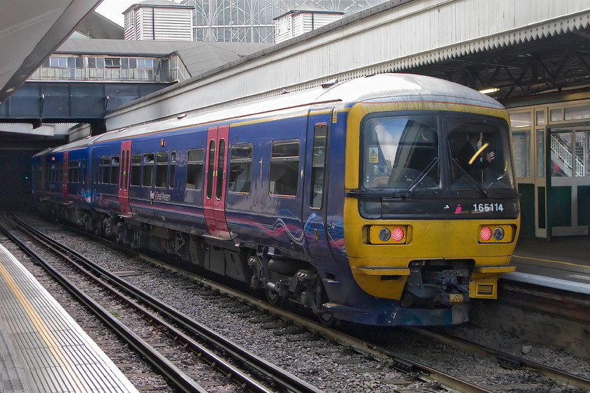 165114, GW 08.27 London Paddington-Oxford (2N18), Paddington LU station 
 Taken from the Bakerloo line platform at Paddington station 165114 is seen on the adjacent Network Rail platform. The Turbo will soon work the 08.27 2N18 stopper to Oxford. Over the coming years, this scene will change as this platform, and all those at Paddington will be wired with new stock occupying them. 
 Keywords: 165114 08.27 London Paddington-Oxford 2N18 Paddington LU station TfL First Great Western