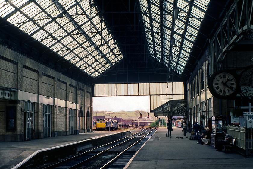 40049, 25291 & 40148, stabled, Blackburn station 
 Balckburn's first station opened in 1846 but with the expansion of the railways soon after this time, it proved inadequate so in 1888 the L & Y built this replacement. It was, in all honesty, a rather gloomy structure with its best feature being a rather grand frontage. However, by 2000 the roof and other parts of the structure were in a serious state of disrepair so the whole station, with the exception of the said frontage, was demolished and a new modern structure was constructed. In this scene, looking south-west through the station, 25291, 40148 and, almost obscured, 40049 can be seen. To the right, a DMU waits to leave southwards towards Manchester or westwards towards Blackpool. Notice the particularly large station clock to the right of the image. 
 Keywords: 40049 25291 40148 stabled Blackburn station