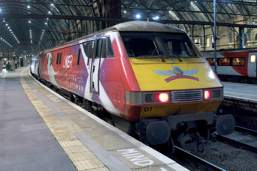 91101, GR 18.00 London King`s Cross-Edinburgh Waverley (1S28, 17L), London King`s Cross station 
 Wearing its unique graphics 91101 looks very smart as it sits at King's Cross leading the 18.00 to Edinburgh Waverley. A 91001, this locomotive was one of the three first built during April 1988 entering service a year later after exhaustive testing and the rectification of a number of technical issues. However, since then they have proved well up to the job of operating fast and heavy trains up and down the ECML, especially since their extensive re-builds in the early 2000s. However, the curtain is about to come down on these fine trains with the Azuma take-over due for completion over the next few months. 
 Keywords: 91101 18.00 London King`s Cross-Edinburgh Waverley 1S28 London King`s Cross station