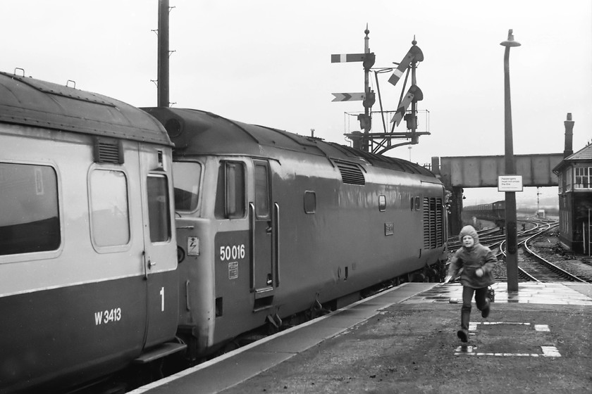 50016, 08.30 Paignton-London Paddington, Westbury station 
 At the eastern end of Westbury station 50016 'Barham' gets the 08.30 Paignton to Paddington underway under the superb up starter bracket. I am not sure who the young boy in full flight was but he has spoilt the picture somewhat. Just behind him, on the platform is my Ferguson 3286 radio cassette recorder and the microphone wrapped in some foam and a white handkerchief. I still have this recording made on this wet day in March 1979. 
 Keywords: 50016 08.30 Paignton-London Paddington Westbury station