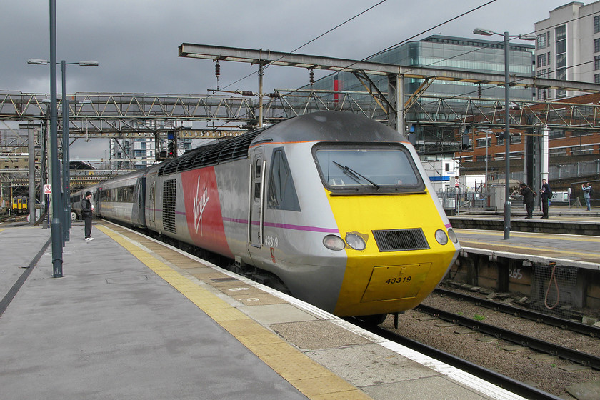 43319, GR 12.35 London King`s Cross-Leeds (1D14), London King`s Cross station 
 Hurridly applied in the last month, the Virgin vinyl flash certainly strikes pose on the side of 43319. It is seen leaving King's Cross at the rear of the 1D14 12.35 to Leeds. It looks as though I am about to get wet judging by the sky to the north of King's Cross; time to head back under the train shed! 
 Keywords: 43319 12.35 London King`s Cross-Leeds 1D14 London King`s Cross station