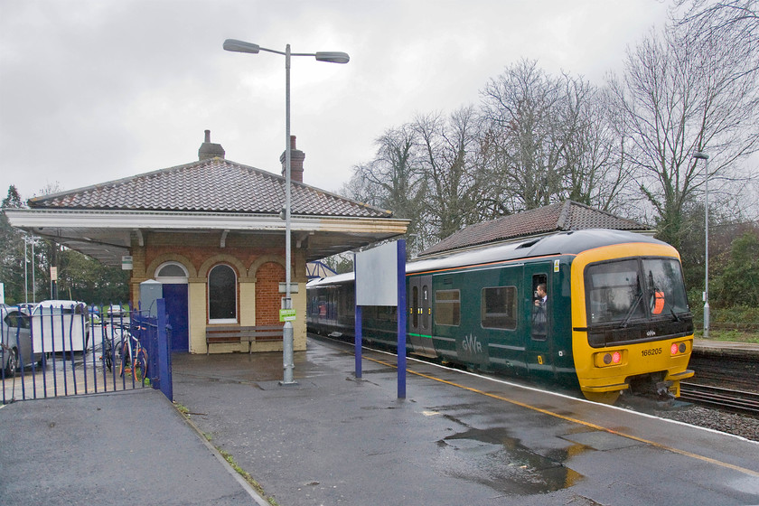 166205, GW 14.37 Basingstoke-Reading (2J40), Mortimer station 
 With the guard looking on 166205 gets underway from Mortimer station working the 14.37 Basingstoke to Reading 2J40 service. Mortimer station is grade II listed for both the main building and matching smaller waiting shelter on the down platform. The station is a superb example of Brunel's Italianate pagoda buildings. These particular ones were in receipt of a major renovation in 1985 as part of the GWR 150 celebrations. 
 Keywords: 166205 GW 14.37 Basingstoke-Reading 2J40 Mortimer station Great Western Railway