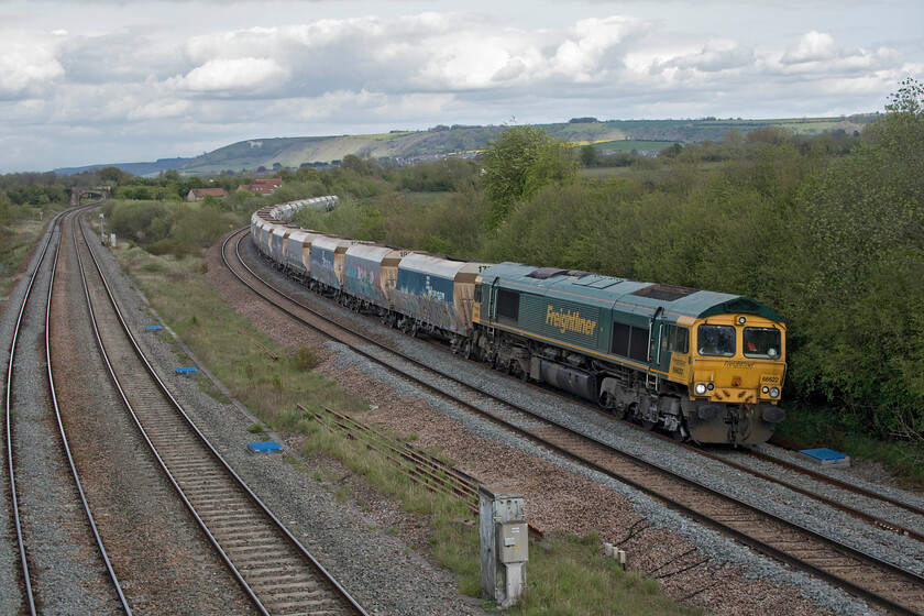 66622, 11.20 Allington-Whatley (6V18, 5E), Fairwood Junction 
 With the northern escarpment of Salisbury Plain and the famous Westbury white horse in the background, 66622 leads the 11.20 Allington to Whatley empty stone train past Fairwood Junction. Back in my teenage spotting days here at Fairwood Junction, a freight would rarely be seen on the 'cut off' with it reserved for fast express services not stopping at Westbury headed by Westerns and Class 50s. 
 Keywords: 66622 11.20 Allington-Whatley 6V18 Fairwood Junction Freightliner