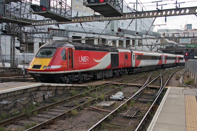 43305, GR 14.00 Edinburgh Waverley-London King s Cross (1E18, 46L), London King`s Cross station 
 Yet another very late arrival at King's Cross station. Arriving forty-six minutes adrift 43305 leads the 14.00 Edinburgh HST service as it weaves into platform six. The building work on the former depot site is growing fast and somewhat encroaches on the station approach as it does. A huge amount of work is about to take place at King's Cross as Network Rail embarks on a programme to increase its capacity. This includes the reopening of the third tunnel to the right and the demolition of the power signal box, built in 1971, with control moving to the York signalling centre. 
 Keywords: 43305 14.00 Edinburgh Waverley-London King's Cross 1E18 London King`s Cross station