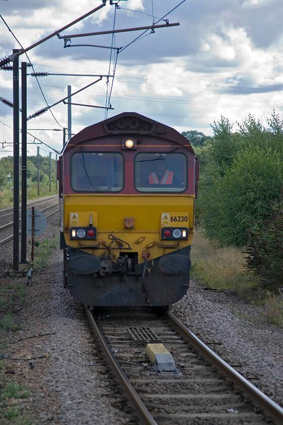 66230, LE for 12.16 Rectory Total Sidings-Lindsey Oil Refinery (6E82), Grantham station 
 The 6E82 Rectory Sidings (Nottingham) to Lindsey Oil Refinery (Immingham) and return have been regular freight fixtures on the railway for many years. It takes an interesting route that requires a locomotive run round at Grantham. This view from the station sees 66230 running round the rake of oil tankers (out of sight to the right) ready to join what was the tail end of the train to continue north along the ECML as far as Doncaster. 
 Keywords: 66230 12.16 Rectory Total Sidings-Lindsey Oil Refinery 6E82 Grantham station EWS