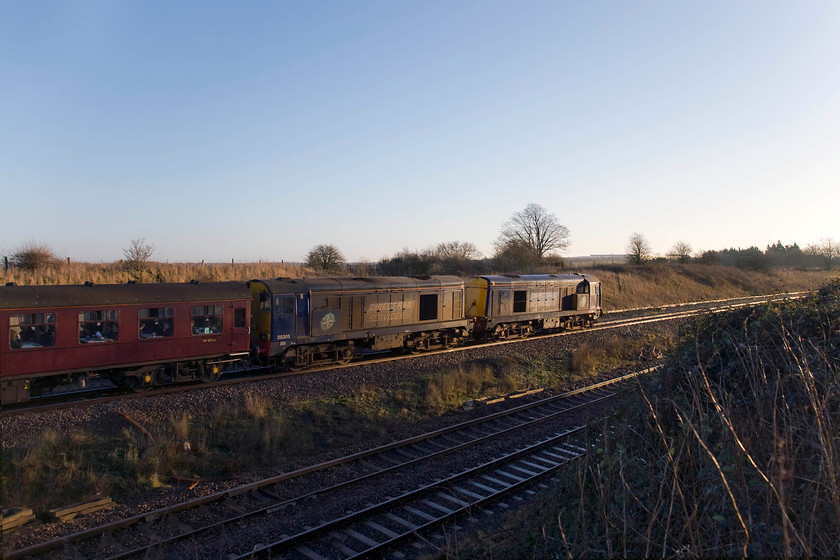 20302, 20305, outward leg of The Deviatoner, 06.22 Crewe-Ely Papworth Sidings (1Z20), Irchester Junction SP922673 
 Catching the early morning winter sunshine 20302 and 20305 get The Deviatoner railtour away from Wellingborough on the approach to Irchester. The Pathfinder tour was the first on the network for 2014 that ran as 1Z20 leaving Crewe at 06.22 for, ultimately, Ely Papworth sidings via some rare tracks and routing. This location is known as Irchester Junction even though there has been no actual junction for many years. The branch to Higham Ferrers via Rushden diverged to the left just beyond where the Class 20s are seen with a signal box set back into the embankment. 
 Keywords: 20302 20305 The Deviatoner 06.22 Crewe-Ely Papworth Sidings 1Z20 Irchester Junction SP922673 Pathfinder Tours