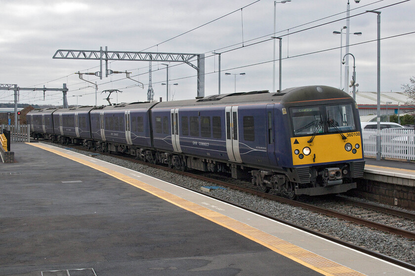 360108, EM 11.15 London St. Pancras-Corby (1Y21, 1L), Wellingborough station 
 360108 arrives at a cold and dull Wellingborough station working the 1Y21 11.15 St. Pancras to Corby EMR Connect service. I find that photographs taken at Wellingborough station give the impression that I have tilted the camera from the horizontal. However, observation of verticals such as lamp posts reveals that this is an optical illusion created by the cant of the tracks, particularly the down fast line, through the station. 
 Keywords: 360108 11.15 London St. Pancras-Corby 1Y21 Wellingborough station East Midlands Railway Connect EMR Desiro