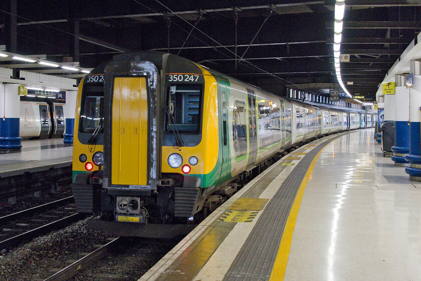 350247, LN 13.54 London Euston-Birmingham New Street (1Y41, 2E), London Euston station 
 Our train home after our short break in London waits in the darkness of Euston station. 350247 along with another four-car unit will work the 13.54 to Birmingham New Street. With the recent announcement that the long-awaited rebuild of Euston is to be 'indefinitely paused' then dismal scenes such as this look like that they will be with us for some time to come! 
 Keywords: 350247 13.54 London Euston-Birmingham New Street 1Y41 London Euston station London Northwestern Desiro