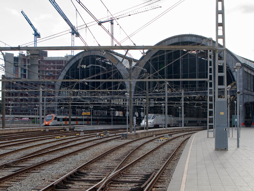 Class 46X, rodalies unidentified working & 130 023, Renfe unidentified working, Barcelona Frana station 
 Despite the huge commercial development in downtown Barcelona, Frana station remains an impressive and commanding structure. The pair of huge iron arches look superb heralding the arrival (or departure) at what was once the city's primary station. Now, it plays a secondary role to Saints station but it is still a firm favourite with many. On this hot late afternoon, an unidentified Rodalies Class 46X and Renfe's 130 023 await their next turns of duty. 
 Keywords: Class 46X, Rodalies unidentified working & 130 023, Renfe unidentified working, Barcelona Frana station