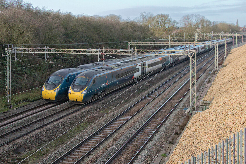 390156, VT 11.25 London Euston-Manchester Piccadilly (1H65, 31L) & 390135, 08.38 Glasgow Central-London Euston (1T09, 2L), Ashton Road bridge 
 A pair of Avanti West Coast Pendolinos pass just south of Roade seen from Ashton Road bridge that has recently reopened after a three-week closure to re-build one of the parapet walls. To the left 390156 'Pride and Prosperity' heads north with the 1H56 11.25 Euston to Manchester service. Whilst to the right, 390135 'City of Lancaster' passes south working the 08.38 Glasgow Central to Euston service. 
 Keywords: 390156 11.25 London Euston-Manchester Piccadilly 1H65 390135 08.38 Glasgow Central-London Euston 1T09 Ashton Road bridge Pride and Prosperity City of Lancaster AWC Avanti West Coast Pendolino