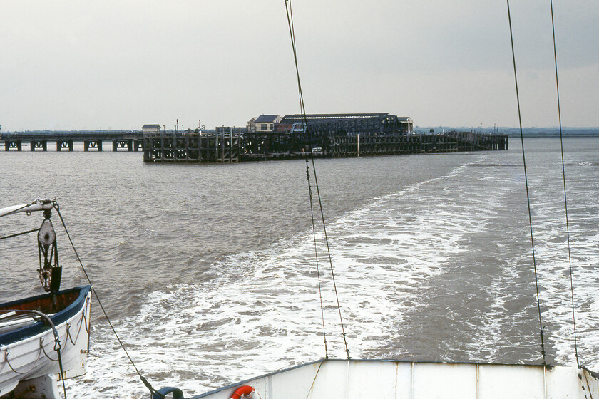 New Holland Pier from MV Farringford 
 Taken from the rear of MV Farringford as it makes its way across the Humber estuary working the 16.50 New Holland to Hull crossing. I refrain from calling it the stern of the vessel as Farringford as it is the same front and rear being a bidirectional vessel. However, I am sure that 'boat-buffs' will put me straight on this and tell me its proper name! Many of the buildings on New Holland Pier, including the signal box to left, still stand as part of the grain export/import facility that now occupies it. 
 Keywords: New Holland Pier from MV Farringford Sealink