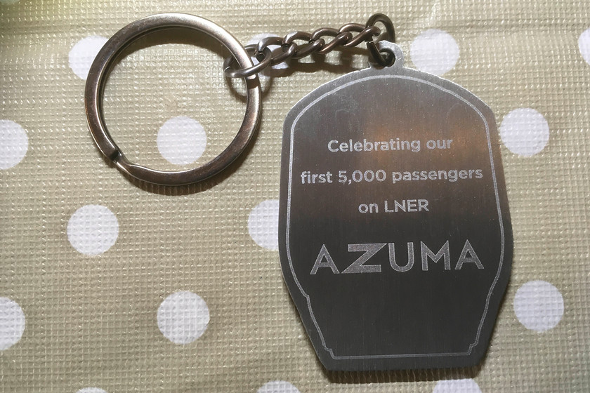 Azuma commemorative keyring 
 This reverse side of the commemorative keyring issued to customers on the launch day of the Azumas on the ECML. This one was given to a friend of mine who traveled from Peterborough to Leeds on 16.05.19. I asked him about his traveling experience. He was favorable about the trains but for one thing. Without any quizzing or prompting, he said the seats were too hard and uncomfortable. Coincidentally, I read a letter in issue 879 of Rail magazine ('Safety before comfort') from somebody stating that this issue has arisen for health and safety reasons relating to fire hazard from foam padding. I find this questionable, are we really being told that in the twenty-first century that there is no preparation or material that can be used as padding on seats? 
 Keywords: Azuma commemorative keyring