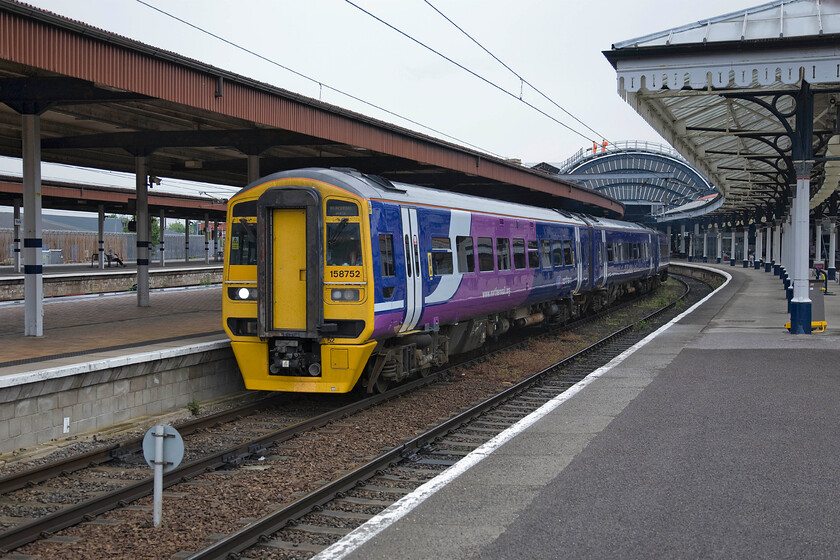 158752, NT 09.18 York-Blackpool North (1B16), York station 
 At York 158752 will soon work the 09.18 to Blackpool North. Notice the bright orange-clad workers on the roof of the train shed; what a view they will have from their lofty position! 
 Keywords: 158752 09.18 York-Blackpool North 1B16 York station Northern