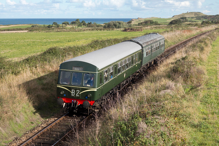 M51192 & M56352, 13.00 Sheringham-Holt, Dead Man`s Bridge 
 Having returned to Sheringham, M51192 and M56352 work back to Holt again with the 13.00 departure. With the coastguard station atop of Skelding Hill and Sheringham golf course in the background, the train is about to pass under the curiously named Dead Man's bridge. One can surmise as to why the bridge may be so named but I do not want to think any more about it! 
 Keywords: M51192 M56352 13.00 Sheringham-Holt Dead Man`s Bridge