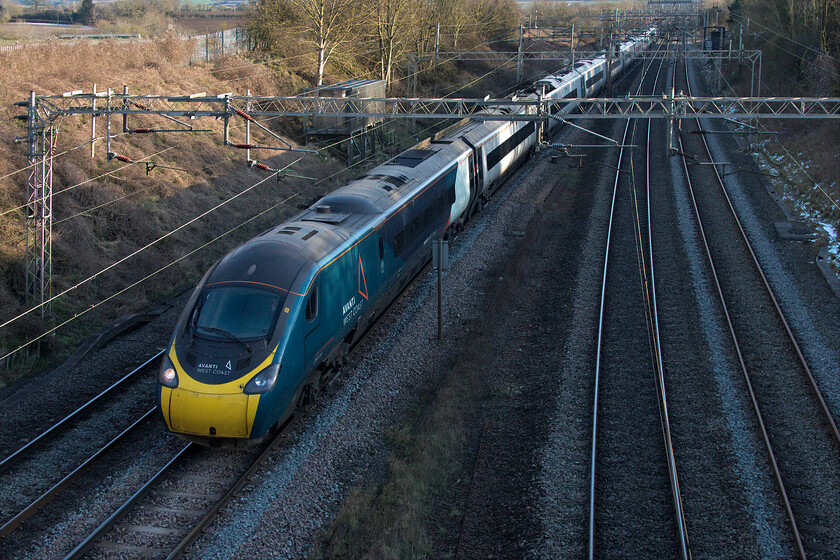 390134, VT 14.58 London Euston-Manchester Piccadilly (1H33, 2L), Victoria bridge 
 390134 'City of Carlisle' is in the shade with the failing afternoon sunshine on this bitterly cold afternoon falling behind the tree line to the south-west of Victoria bridge. The Pendolino is on the down slow line that will take it through Northampton working the 14.58 Euston to Manchester 1H33 Avanti West Coast service. The diversion was due to the protracted closure of the down main line at Hillmorton Junction due to embankment repairs being required following recent heavy rain. 
 Keywords: 390134 14.58 London Euston-Manchester Piccadilly 1H33 Victoria bridge Avanti West Coast Pendolino City of Carlisle