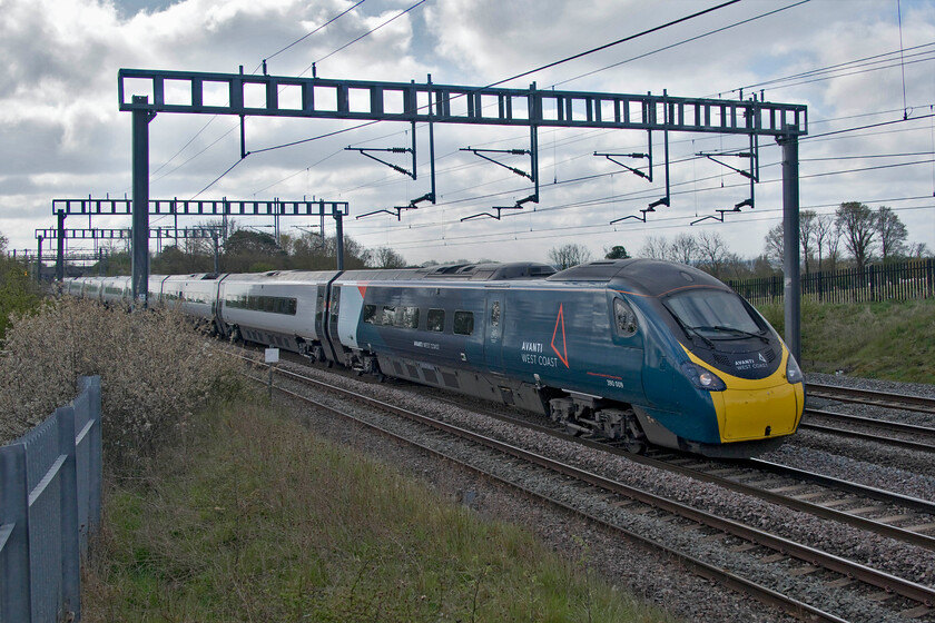 390009, VT 08.51 London Euston-Wolverhampton (9G02, RT), Ashton Road bridge 
 390009 'Treaty of Union' works the 08.51 Euston to Wolverhampton Avanti service between the villages of Roade and Ashton. The Pendolino is on the slow line taking it through Northampton as is common practice on Sunday mornings on this section of the WCML. By mid-morning, the fast lines are usually reopened and trains can return to their usual routes and timings! 
 Keywords: 390009 08.51 London Euston-Wolverhampton 9G02 Ashton Road bridge Treaty of Union Avanti West Coast