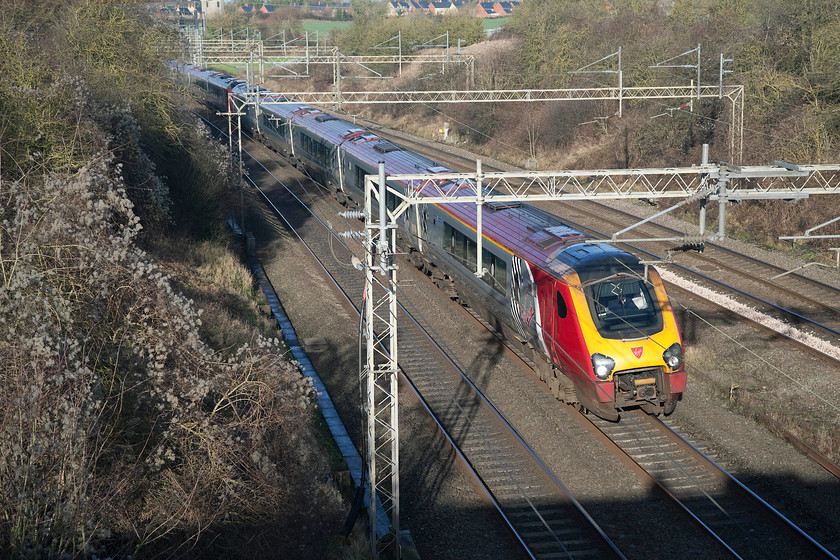 Class 221s, VT 05.49 Glasgow-C-London Euston (9M48, RT), Victoria-Bridge 
 Despite leaving Glasgow central forty minutes earlier than the 06.30 working to London Euston, this one has taken longer to reach here. It is now ten minutes behind the 06.30 formed by a Pendolino. These 221s will have gone via the 'old' WCML route through Birmingham, hence their longer journey time. The unidentified Voyagers are seen passing Victoria Bridge on the WCML near to Roade. 
 Keywords: Class 221 9M48 Victoria Bridge WCML Roade