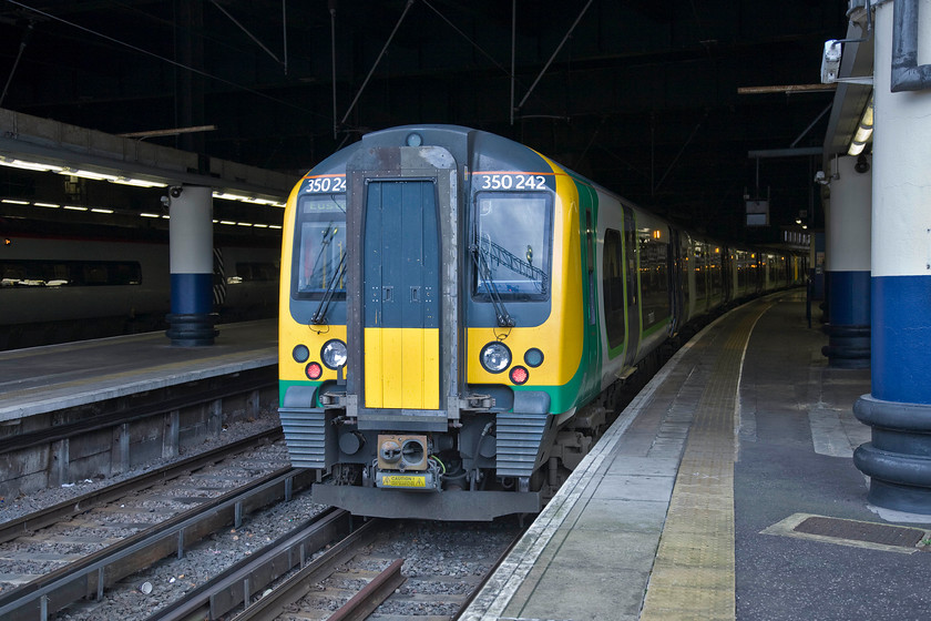 350242, LM 15.34 London Euston-Birmingham New Street (15.34 London Euston-Milton Keynes), London Euston station 
 Our train home from London to Milton Keynes just pokes its nose into the daylight leaving the rest firmly in the gloom that is Euston station! My wife, son and I took 350242 working the 15.34 to Birmingham New Street finding it reasonably busy with no problem finding seats together. However, there were a further two sets out of sight in this image meaning that it was a twelve car train. 
 Keywords: 350242 15.34 London Euston-Birmingham New Street London Euston station London Midland Desiro