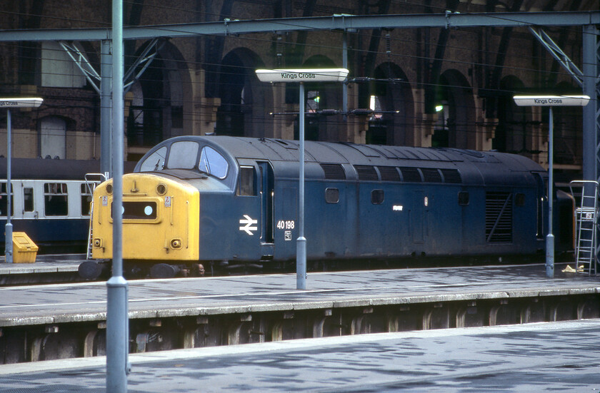 40198, for 16.30 London King's Cross-Peterborough (1B30), London King's Cross station 
 40198 eases into King's Cross station to then attach to its stock. Then it will work the 1B30 16.30 commuter service to Peterborough. This particular service was often hauled by a Class 40 giving enthusiasts a chance to get some lively English Electric haulage on the ECML. With no motor drive on my Pentax ME Super (not that I could afford to waste Kodachrome 64 transparencies using this facility!) I had to rely on my eye and judgement to place locomotives; as can be seen here, I did not always get it right! 
 Keywords: 40198 16.30 London King's Cross-Peterborough 1B30 London King's Cross station Whistler