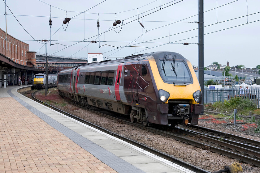 91105, GR 14.30 London King's Cross-Newcastle (1N21) & 220032, XC 08.32 Penzance-Glasgow Central (1S47), York station 
 Despite the brightness, it was actually spotting with rain here at York station! To the left 91115 pauses at the head of the 1N21 14.30 King's Cross to Newcastle. To the right, CrossCountry's 220032 Voyager gets away working the 08.32 Penzance to Glasgow Central service. In BR days this train would have travelled to Birmingham and then would take the more direct route to Glasgow via the West Coast Mainline. 
 Keywords: 91105 14.30 London King's Cross-Newcastle 1N21 220032 08.32 Penzance-Glasgow Central 1S47 York station Cross Country Voyager East Coast InterCity 225