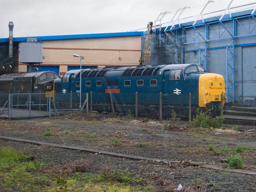 D6700 & 55002, stabled, NRM Yard 
 On entering York station and passing the National Railway Museum two locomotives were on display outside in the rain. In the foreground is 55002 'The King's Own Yorkshire Light Infantry' with Type 3 D6700 stabled behind it. The Deltic would have passed this spot countless numbers of times during its working life on the ECML up until its withdrawal on 02.01.82. 
 Keywords: D6700 55002 stabled NRM Yard The King's Own Yorkshire Light Infantry