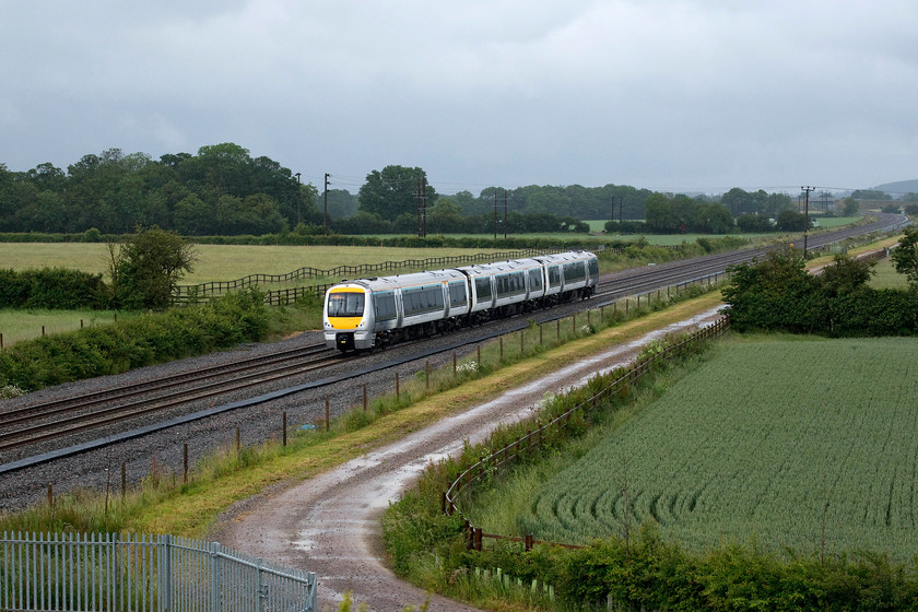 168110, CH 14.35 London Marylebone-Oxford (1T39, RT), Oddington SP542160 
 After an hour or so of torrential rain that nearly persuaded us to turn for home, 168110 passes near to the village of Oddington with the 14.35 Marylebone to Oxford Chiltern service. The picture is taken from one of the recently constructed bridges that cross the stretch of line between Bicester and Oxford that itself has undergone huge upgrading as the first phase of the long-awaited east-west route; will it ever be finished? 
 Keywords: 168110 14.35 London Marylebone-Oxford 1T39 Oddington SP542160