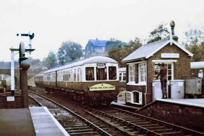 Class 100 DMU, unidentified Pickering-Grosmont working, Goathland station 
 The North Yorkshire Moors Railway used this class 100 DMU for a number of years during the 1970s. It was painted into an LNER style of green and white and frequently carried the National Park Scenic Service headboard. Sc50341 and Sc56097 arrive at Goathland with a Pickering to Grosmont working with the signallman and driver about to exchange tokens. 
 Keywords: Class 100 DMU Pickering-Grosmont working Goathland station