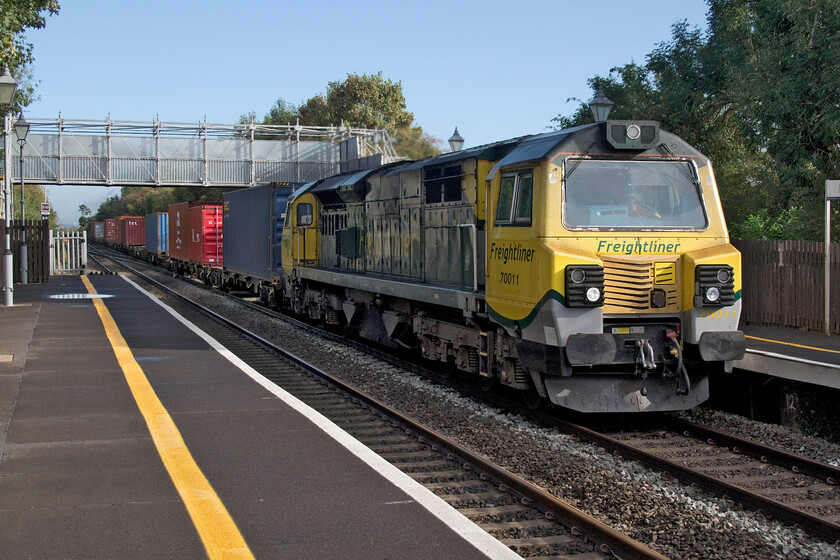 70011, 05.34 Crewe Basford Hall-Southampton MCT (4O14, 5L), Tackley station 
 Unfortunately taken the wrong side of the early morning sunshine at Tackely station 70011 passes at speed leading the 05.34 Crewe to Southampton Freightliner. The delightful quietness of Tackely village is frequently shattered by trains as they pass particularly so when a Class 70 is at the helm! 
 Keywords: 70011 05.34 Crewe Basford Hall-Southampton MCT 4O14 Tackley station Freightliner