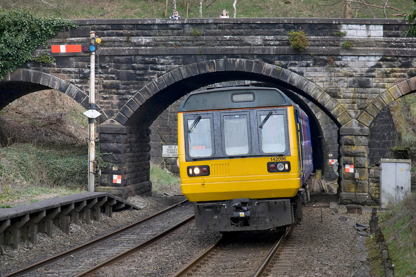 142096, NT 14.14 Sheffield-Manchester Piccadilly (2S41), Grindleford station 
 142096 has just emerged from Totley tunnel, the portal of which can be seen just behind the unit beyond the bridge working the 14.14 Sheffield to Manchester Piccadilly Northern Trains service. Notice the two children standing on the bridge leaning over the parapet doing what children have done on railway bridges for years, watching trains go by! 
 Keywords: 142096 14.14 Sheffield-Manchester Piccadilly 2S41 Grindleford station