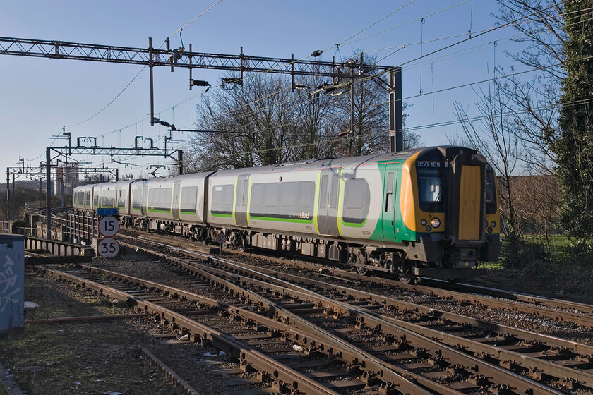 350109, LM 09.13 London Euston-Birmingham New Street, Northampton station car park 
 London Midland's 09.13 Euston to Birmingham New Street arrives at Northampton taken from the station's car park. It is worked by 350109 and another unidentified unit at the rear. The line curving off to the left used to lead to Bridge Street station and onwards along the Nene Valley towards Wellingborough and Peterborough. It also led to the Northampton steam shed (4B) and onward to the WCML which it joined at Blisworth as an alternative to the present-day route that prevailed during the 1960s rationalisation. 
 Keywords: 350109 09.13 London Euston-Birmingham New Street Northampton station car park London Midland Desiro