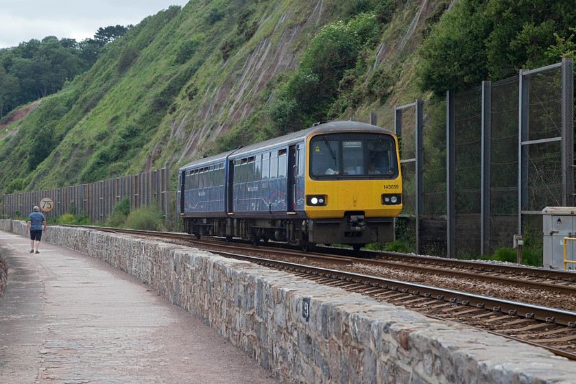 143619, GW 15.13 Paignton-Exmouth (2F41, 1E), Parsons Tunnel 
 143619 heads along the sea wall approaching Parsons Tunnel working the 15.13 Paignton to Exmouth working. The work completed to stabilise the cliff face and protect the railway is clear in this image. Much hard engineering is needed the whole length of this stretch of line to maintain its integrity and this will need to continue over the coming years. 
 Keywords: 143619 2F41 Parsons Tunnel