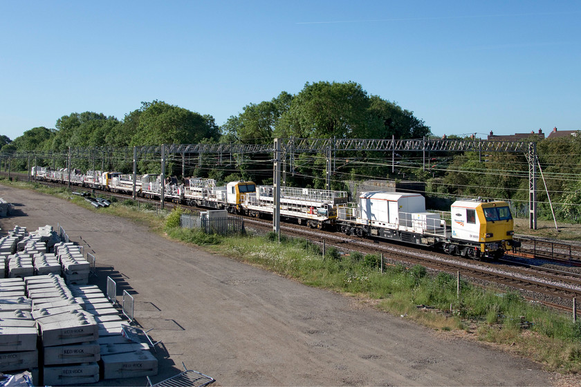 DR98009, DR98011, DR98004 & DR98003, 07.00 Willesden West London Junction-Rugby Depot Access Line (4E), site of Roade station 
 Making their way sedately along the down slow line at Roade is a quartet of Network Rail Windhoff Overhead Line Train MPVs forming the 07.00 Willesden to Rugby. The formation is made up of DR98009, DR98011, DR98004 and DR98003 that headed south two days previously but promptly failed. See..... https://www.ontheupfast.com/p/21936chg/29056406404/dr98003-dr98004-dr98011-dr98009 
 Keywords: DR98009 DR98011 DR98004 DR98003 07.00 Willesden West London Junction-Rugby Depot Access Line site of Roade station