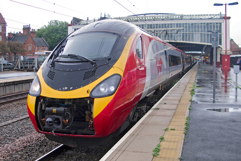 390121, VT 09.20 London Euston-Manchester Piccadilly (1H15), Stoke-on-Trent station 
 390121 pauses ar Stoke-on-Trent station having arrived with the 09.20 Euston to Manchester 1H15 Virgin service. Looking particularly ugly and unstreamlined with its coupling cover folded up my wife and I had travelled on this train from Milton Keynes. 
 Keywords: 390121 09.20 London Euston-Manchester Piccadilly 1H15 Stoke-on-Trent station Virgin Trains Pendolino