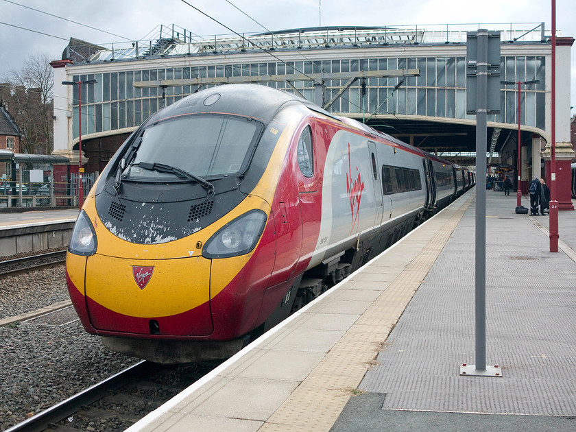 390128, VT 10.20 London Euston-Manchester Piccadilly (1H18), Stoke-on-Trent station 
 Having travelled up from Milton Keynes, 3980128 'City of Preston' waits at Stoke-on-Trent to continue its journey to Manchester Piccadilly as the 10.20 from Euston. This view does not show Stoke station's glazed train shed off to best effect. Whilst it's not the most appealing from this angle, the rest of the station is quite impressive being built by the North Staffordshire Railway Company opened in 1849. 
 Keywords: 390128 10.20 London Euston-Manchester Piccadilly 1H18 Stoke-on-Trent station