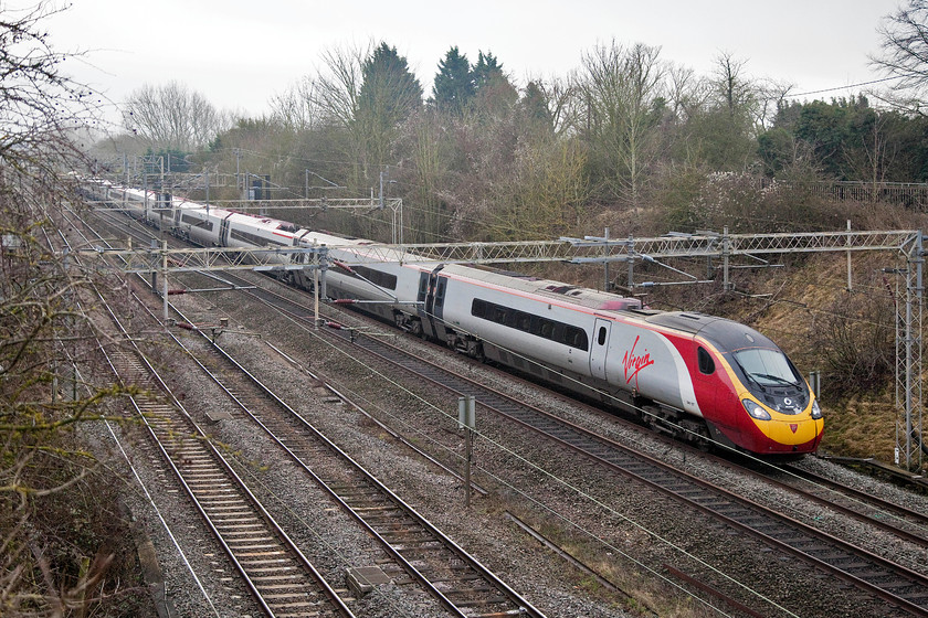 390127, VT 11.07 London Euston-Liverpool Lime Street (1F15, 11L), Victoria Bridge 
 With its front end looking a little tatty, 390127 'Virgin Buccaneer' forms the 11.07 Euston to Liverpool. This slightly wider angle picture at Victoria Bridge involved me doing some pruning of some extensive ivy that had begun to envelop this end of the bridge parapet. 
 Keywords: 390127 11.07 London Euston-Liverpool Lime Street 1F15 Victoria Bridge