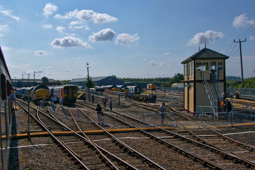 Barrow Hill from shuttle train 
 The view from the returning shuttle train affords a wide angled view of Barrow Hill's site and much of the stock on display. The large building in the centre is the home to the Deltic Preservation Society. Also, notice the smartly painted Midland signal box to the right. Whilst it is positioned appearing to control the entry and exit to the yard's roads it is in fact a dummy box with no plans for it to become operational. 
 Keywords: Barrow Hill from shuttle train