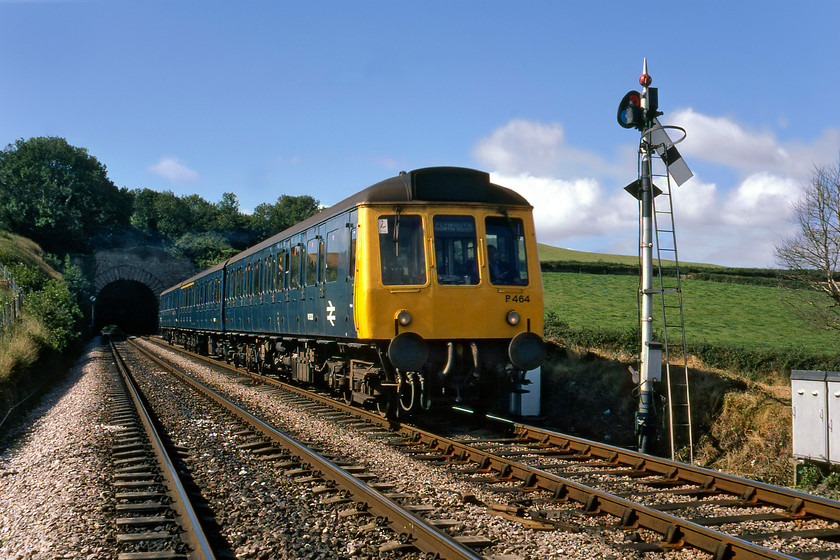 W51321, W59473 & W51306, 10.05 Plymouth-Paignton, Dainton Tunnel SX852665 
 Even on a quiet Sunday morning, I would never recommend getting into a position such as this to get a train photograph! I am not at all sure what on earth the driver would have thought but close examination of the scan reveals that he is not even looking at us! A Class 118 DMU, set P464 has just emerged from the eastern end of Dainton tunnel about to pass its up home signal working the 10.05 Plymouth to Paignton service. This train would reverse at Newton Abbot to continue its journey. This would have been the first point where the driver would have a chance to report two trespassers on the line in the days before mobile 'phones. 
 Keywords: W51321 W59473 W51306 10.05 Plymouth-Paignton Dainton Tunnel SX852665 Class 118 DMU set p464