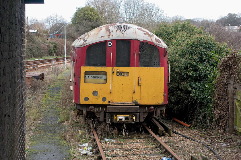 483004, stored, Ryde St. John`s Road station 
 Allegedly, 483004 in a serviceable condition! It is seen just to the north of Ryde St. Jonh's Road station on a very rusted piece of track indicating that it has not moved for some time. When the summer season starts about Easter time, I believe that The Island Line needs three sets of class 483s in service. So, maybe 004 will work again for one last season prior to the Vivarail class 484s taking over services, themselves re-built from D78 stock dating from the mid-1970s. 
 Keywords: 483004 stored Ryde St. John's Road depot Island Line SWT 1938 London Underground stock