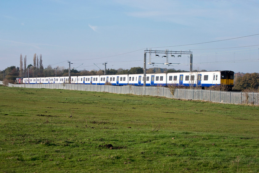 37800, 315846 & 315845, 05.22- Ilford EMUD-Kingsbury Sidings, Wilsons Crossing 
 315845, formally 'Herbie Woodward', and 315846 are dragged by 37800 'Cassiopeia' on their final journey from Ilford to Kingsbury for scrapping. After doing nearly thirty years of service around London these BREL (York) built EMUs are being replaced by new stock on the East London Lines. The train is seen heading away from Wilson's Crossing close to the Kingsthorpe area of Northampton. 
 Keywords: 37800 315846 315845 05.22 Ilford EMUD-Kingsbury Sidings Wilson's Crossing