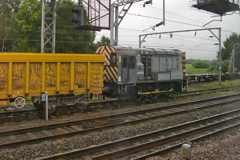 09204, stabled, Crewe South 
 Undertaking some shunting duties to the south of Crewe, 09204 sits attached to a line of Polish built IOA bogie box wagons. There is a general misunderstanding in the railway fraternity that the Class 09s are a more powerful version of the Class 08 shunters. They are in fact identical having the same 350hp English Electric 6KT engine with the only difference being slightly higher gearing. This means that they can reach the dizzy heights of twenty-seven and a half miles per hour! However, it does reduce their maximum tractive effort slightly. Whilst some Class 09s were converted from 08s, this example was one of the original twenty-six constructed at Horwich works entering service in December 1961 as D4112. Apart from being stored for a year between 2011 and 2012, it has been in continual service since its introduction; quite some testament to the design! 
 Keywords: 09204 Crewe South Gronk shunter