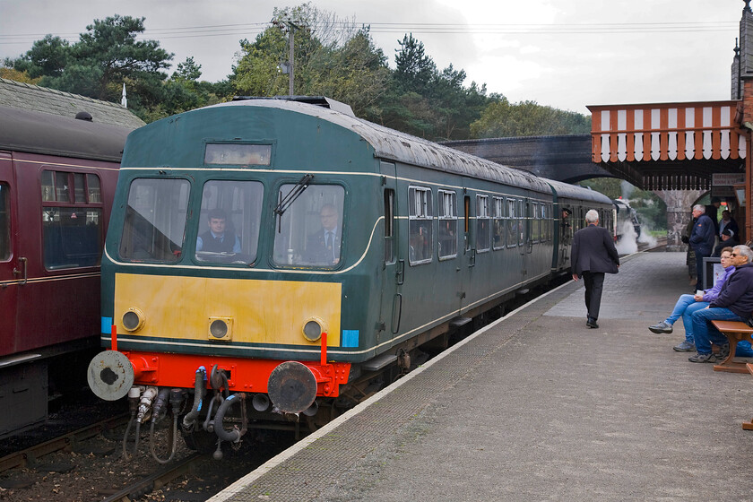 M56352 & M51192, 10.30 Holt-Sheringham, Weybourne station 
 Looking a little faded now after doing a number of years' worth of faithful service on the North Norfolk Railway one of their resident DMUs formed from M56352 and M51192 waits at Weybourne station to work the 10.30 Holt to Sheringham service on a busy Sunday morning. Just visible under the bridge Black 5 44767 'George Stephenson' is just getting the 10.30 Sheringham to Holt train away. 
 Keywords: M56352 M51192 10.30 Holt-Sheringham Weybourne station Class 101 DMU