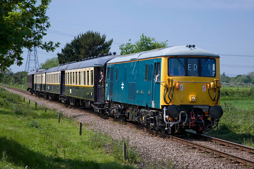 73001, 13.12. Yarwell Junction-Peterborough NV (1E50), Ailsworth TL109979 
 Built in 1962 at Eastleigh Works as E6001 this electro-diesel (ED) worked throughout its life on the Southern Region eventually withdrawn in May 2000. As the pioneer member of the class it was preserved and now does the rounds of the galas looking superb in its BR blue livery. Hauling a very non-authentic rake of continental stock it approaches Ailsworth crossing working the 13.12 Yarwell Junction to Peterborough Nene Valley. 
 Keywords: 73001 13.12. Yarwell Junction-Peterborough Nene Valley 1E50 Ailsworth TL109979 ED Electro Diesel