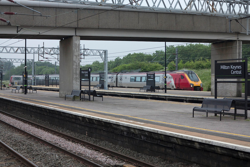 221104, VT 10.10 London Euston-Chester (1D84, RT), MKC station 
 With much of the concrete that dominates throughout Milton keynes in evidence, 221104 'Sir John Franklin' draws into its station working the 10.10 London Euston to Chester. Sir John Franklin was an Arctic explorer who died in 1843 when he and his expedition got trapped whilst attempting to explore and navigate the North West Passage. 
 Keywords: 221104 1D84 Milton Keynes Central station