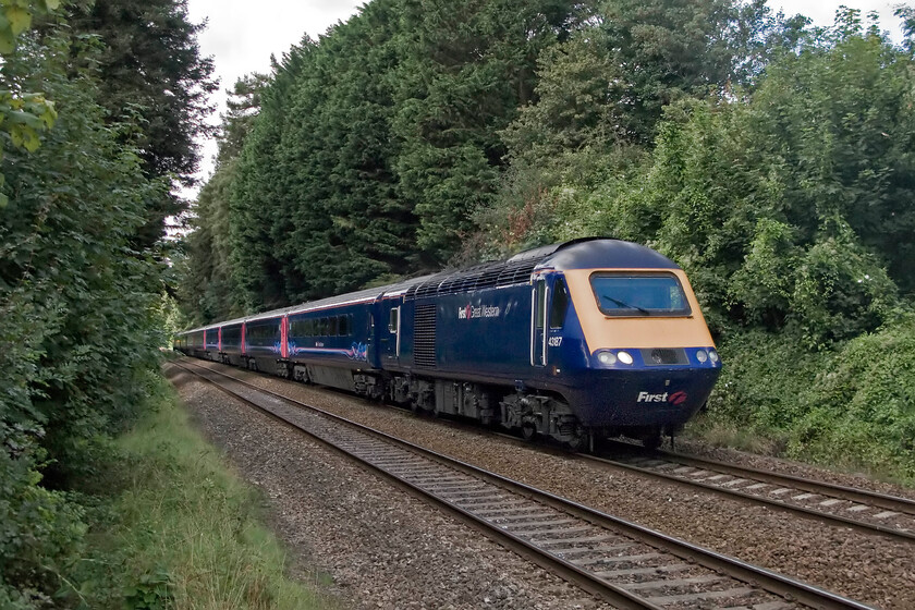 43187, GW diverted 11.00 Cheltenham-London Paddington (1L50), Bradford-on-Avon number 2 crossing 
 The 11.00 Cheltenham Spa to Paddington HST service, led by 43187, is off-route passing through the Avon Valley on the approach to Bradford-on-Avon being diverted due to electrification works on its usual route. I stood in a very similar spot back in 1977 photographing a Class 31 on a Bristol to Portsmouth Harbour train, see.. https://www.ontheupfast.com/p/21936chg/23615754204/x31223-ambles-past-one-bradford-avon but this time not on the track even if it was at a foot crossing! 
 Keywords: 43187 11.00 Cheltenham-London Paddington 1L50 Bradford-on-Avon First Great Western HST