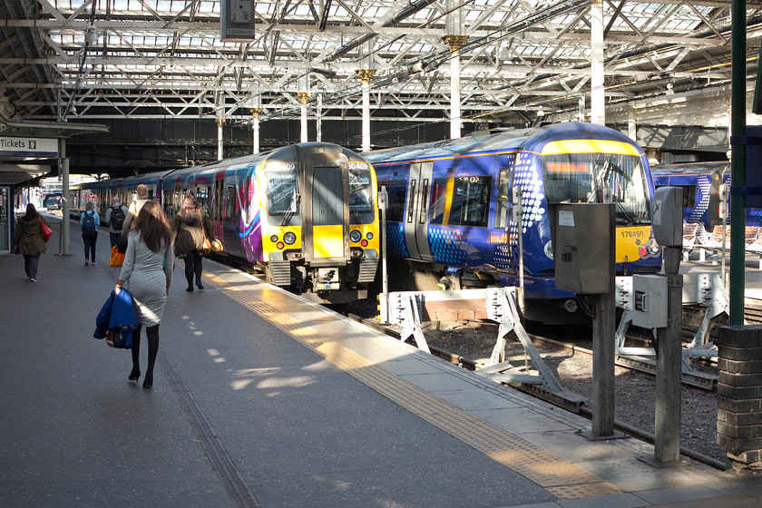 350409,TP 10.08 Edinburgh Wavereley-Manchester Airport (1M95) & 170460, SR 10.03 Edinburgh Waverley-Dunblane (2P33), Edinburgh Waverley station 
 Passengers for the TPE 10.08 service to Manchester Airport make their way along the platform to board 350409 in its rather gaudy livery. Next to it, 170460 will leave just before the Desiro forming the 2P33 10.03 to Dunblane. The picture is taken from the gate line that prevented me gaining access to the platform that stopped me composing a better picture! 
 Keywords: 350409 10.08 Edinburgh Wavereley-Manchester Airport 1M95 170460 10.03 Edinburgh Waverley-Dunblane 2P33 Edinburgh Waverley station