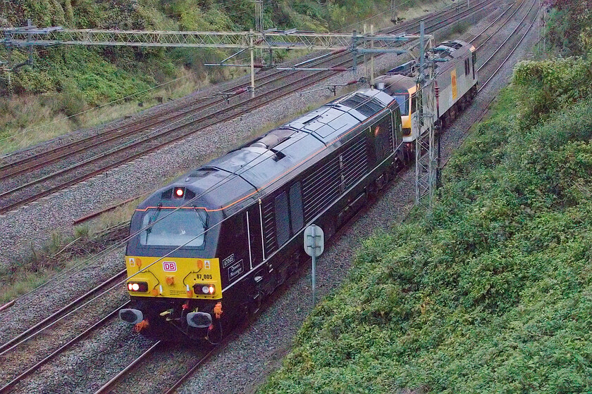 67005 & 92041, 13.32 Crewe TMD-Wembley HS (0A06, RT), Victoria bridge 
 Now, in desperate light, the 13.32 Crewe TMD to Wembley Yard light engine move passes Victoria bridge just south of Roade. The sight of a Class 92, all be it dead, is, apart from the Caledonian Sleeper services that is, rare. 92041 'Vaughan Williams' is being led as 0A06 by 67005 'Queen's Messenger'. 
 Keywords: 67005 92041 13.32 Crewe TMD-Wembley HS 0A06 Victoria bridge Vaughan Williams